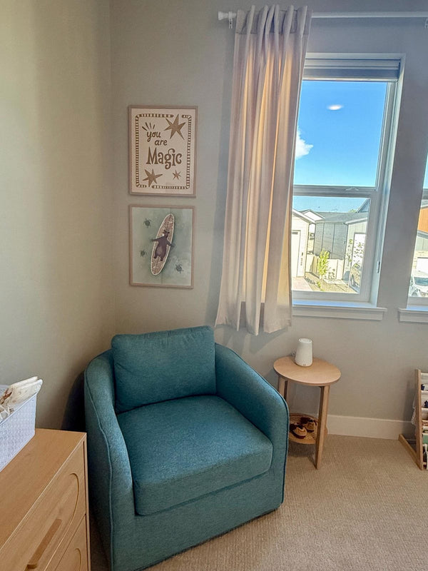 You Are Magic print framed and hung above a teal armchair in a nursery