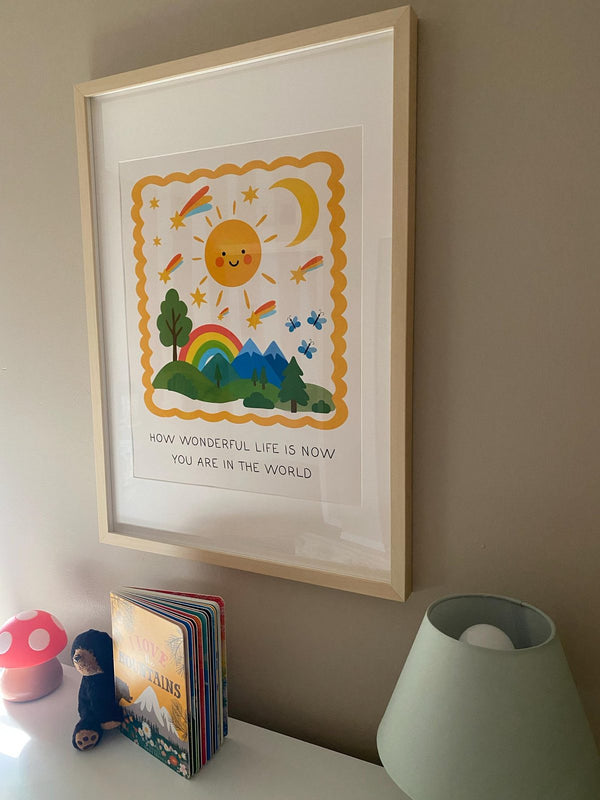 How Wonderful Life Is Now You're In The World print framed and hung above a nursery nightstand